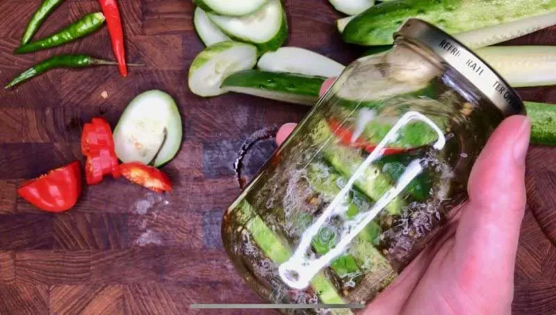 Shaking jar with ingredients with closed lid