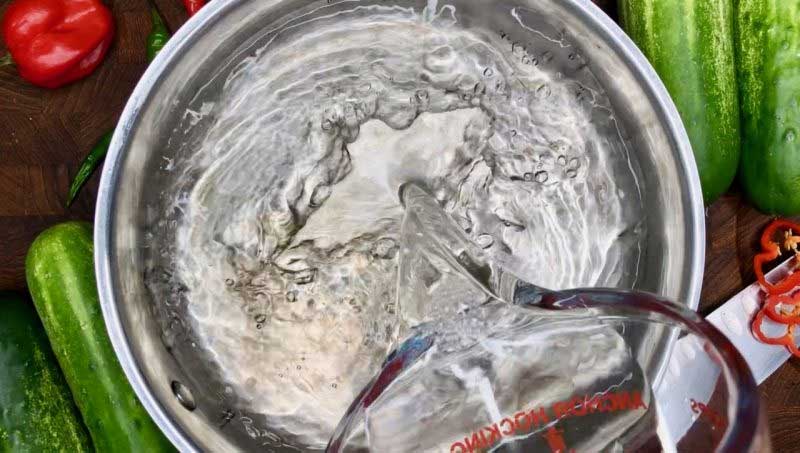 Pouring vinegar into a pot to make brine