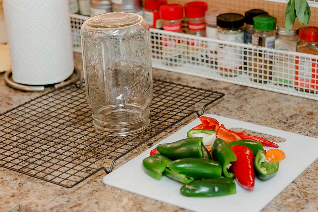 Pepper Jar drying on rack with washed peppers on cutting board