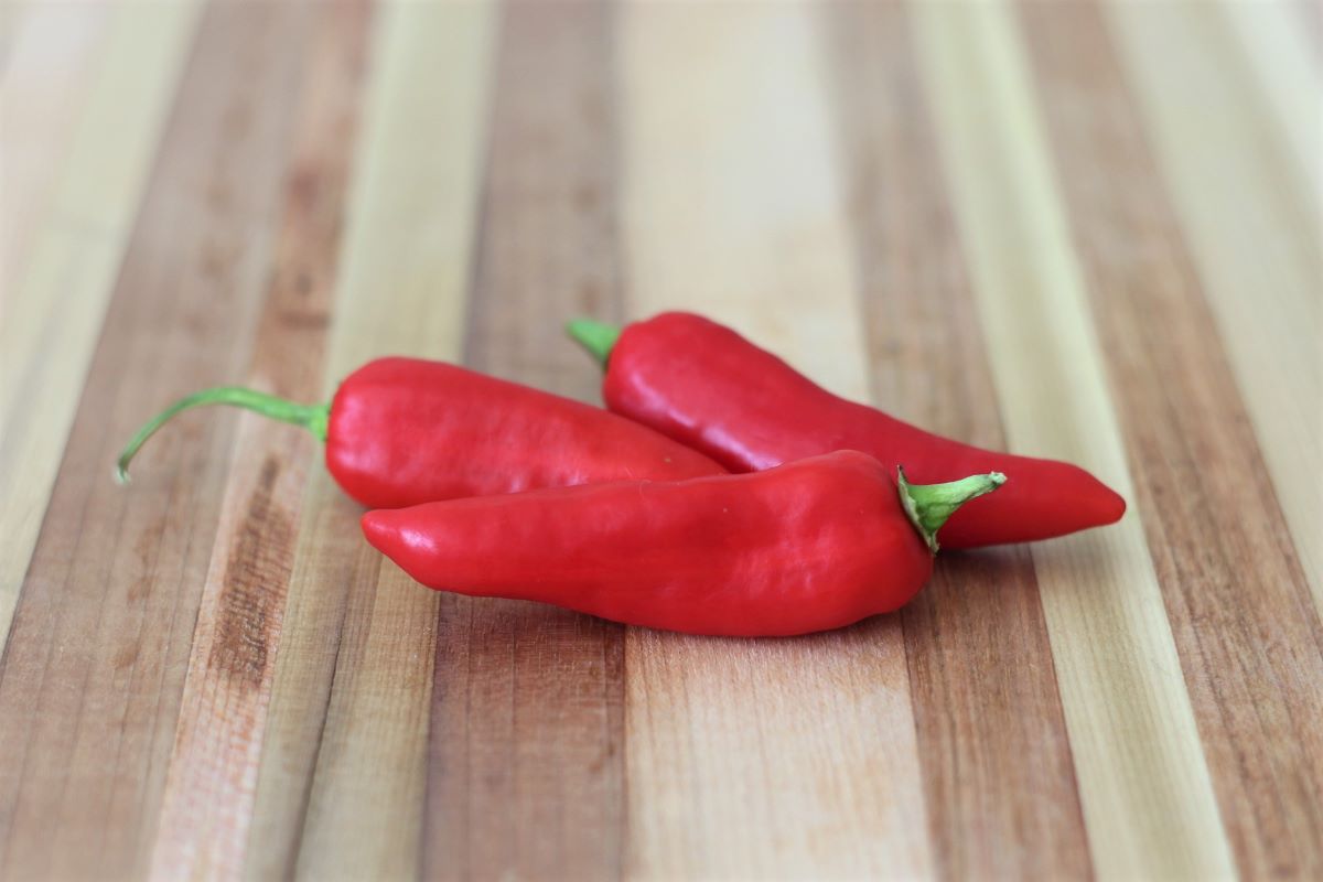 Ripe red fish peppers on cutting board