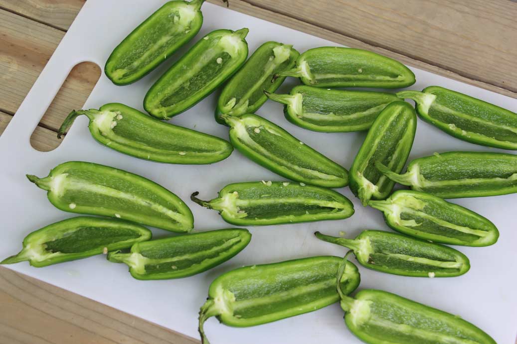 Jalapeno peppers sliced in half lengthwise.