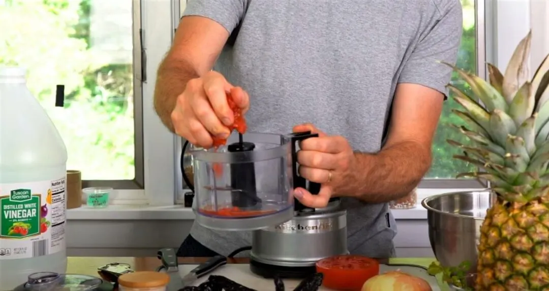 Squeezing Tomato Juices Out Into Food Processor