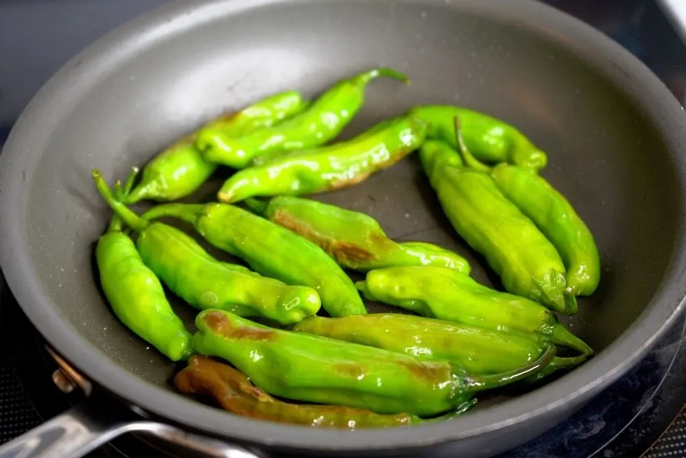 Shishito peppers cooking in oil