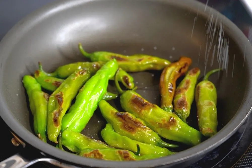 Adding salt to blistered shishitos