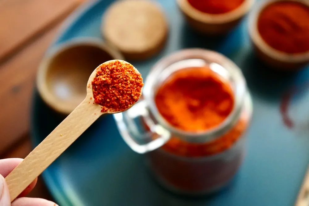 Cayenne powder in wooden spoon