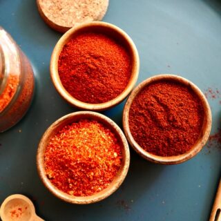 Paprika, chili powder, and cayenne powder in bowls