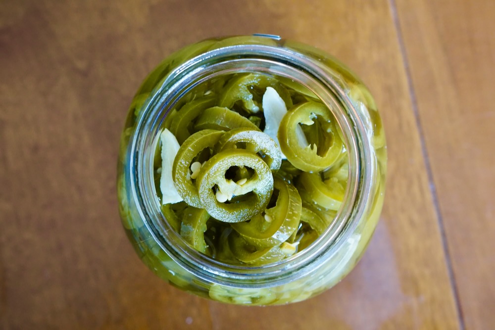 Pickled jalapeno pepper slices in mason jar
