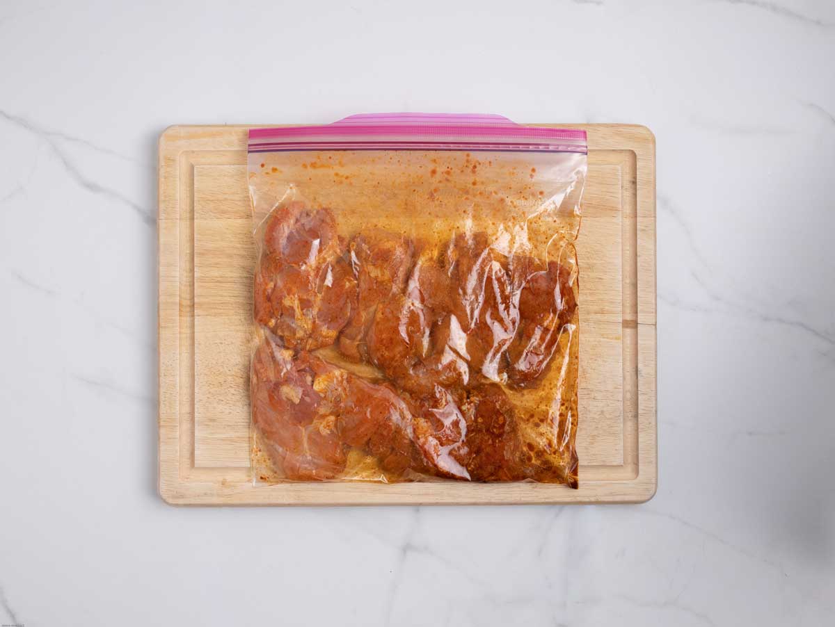 Chicken marinating in bag