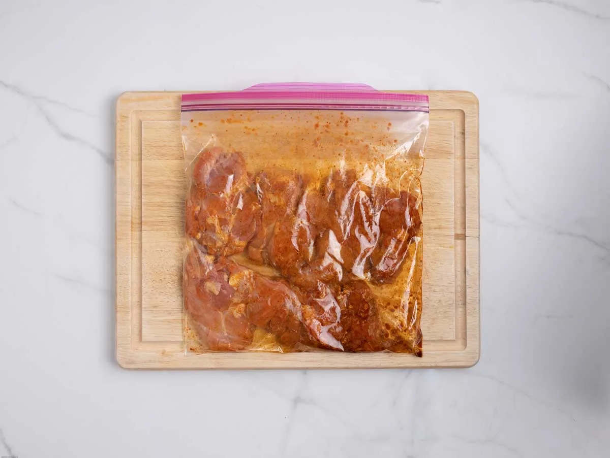 Chicken marinating in bag