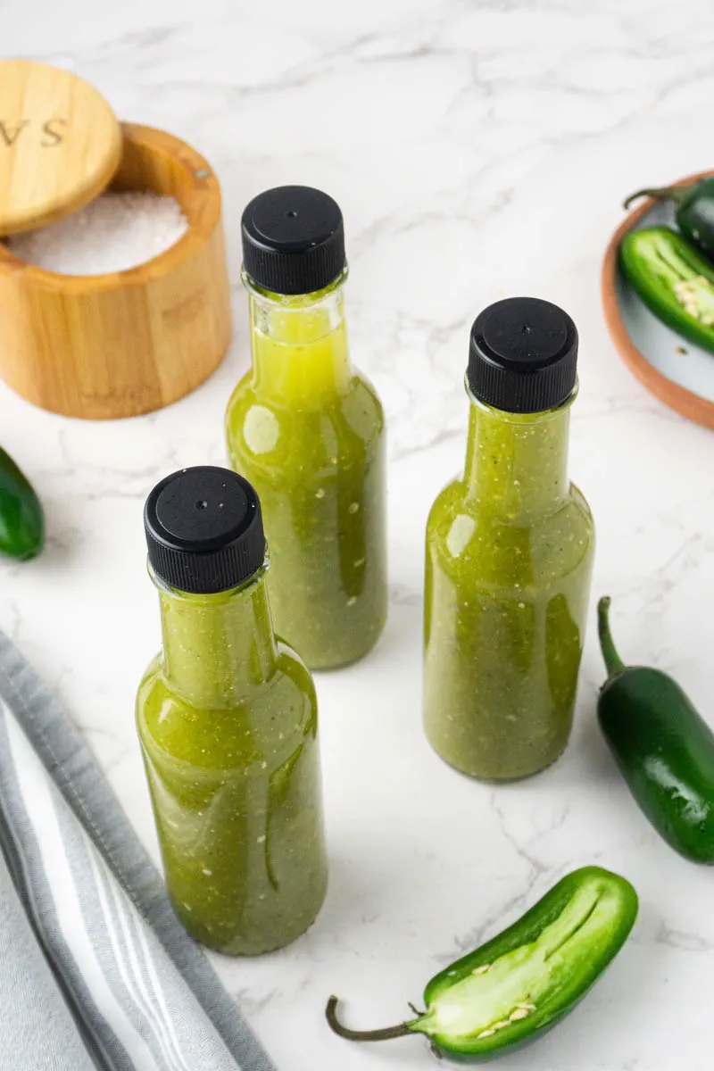 homemade jalapeño hot sauce in bottles