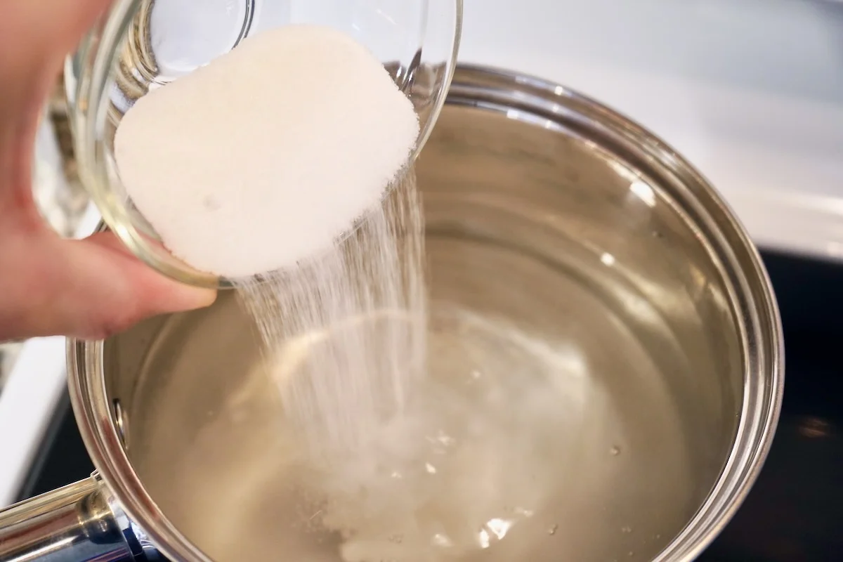 Adding salt and sugar to brine