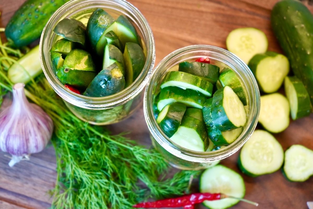Jars filled with cucumbers dill and spices