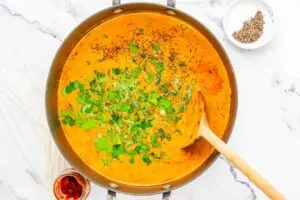 Adding herbs to Thai soup