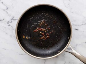 Peppercorns in pan with oil