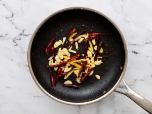Sichuan peppers and ginger in pan