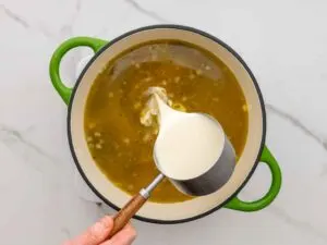 Adding cream to chicken poblano soup