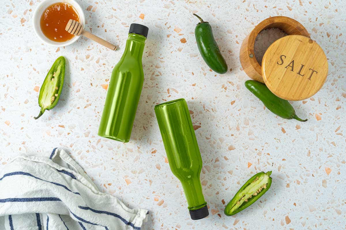 Overhead shot of 2 bottles of jalapeno hot sauce