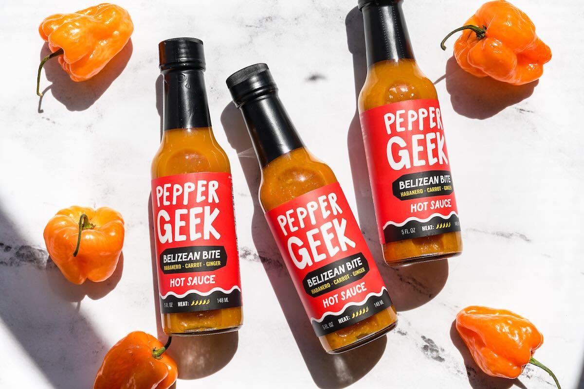 3 bottles of Pepper Geek Belizean Bite hot sauce with habanero peppers