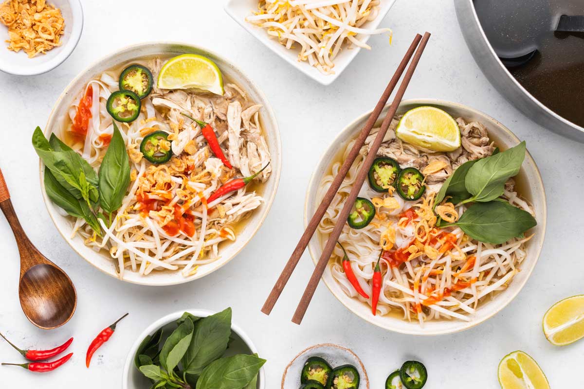 Overhead shot of two bowls of homemade chicken pho